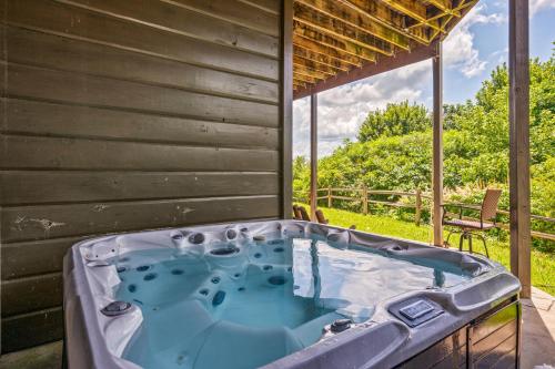 a jacuzzi tub in the backyard of a house at The King Of The Mountain - 6617 Sq Ft sleeps 22 amazing mountain views, Private Indoor Pool in Sevierville