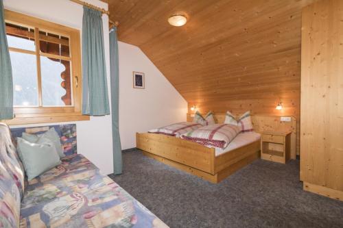 a bedroom with two beds in a wooden cabin at Innerkumpflhof in Anterselva di Mezzo