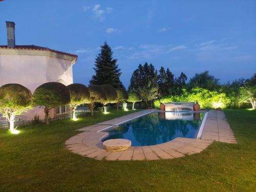 a backyard with a swimming pool in a yard with lights at Villa Silene in Covilhã