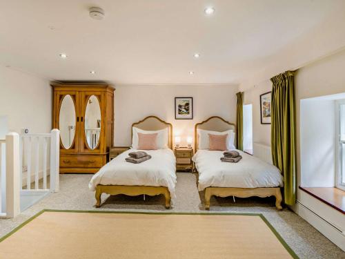 a bedroom with two beds and a window at 6 Bed in Martindale 95344 in Patterdale