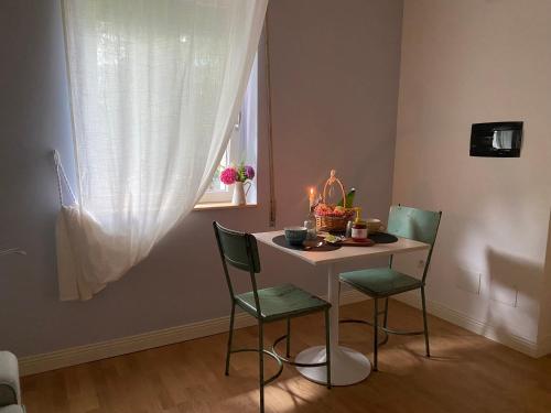 a small table with two chairs and a table with candles at B&B Cà Selvetta in Forcola
