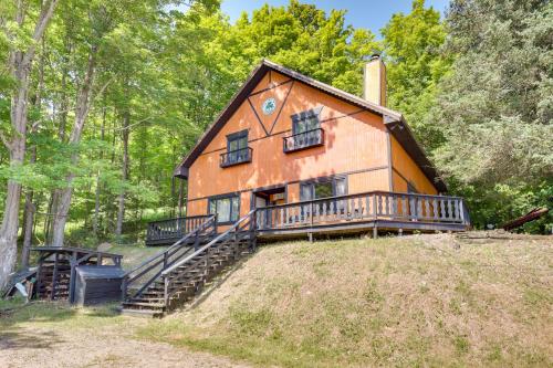 a house on top of a hill with trees at Outdoor Lovers Paradise Slope-View Cabin! in Iron River