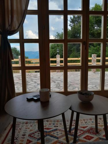two tables in a room with a window at Wild peace Vladimir in Foča