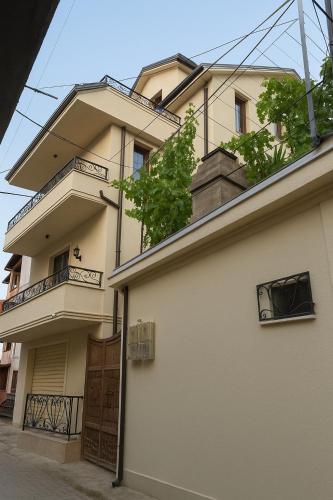 a large building with balconies on top of it at Tomas Inn in Pogradec