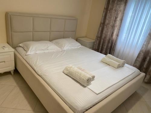 a bed with two towels on top of it at Vacation Home Kondi Ilia in Petran