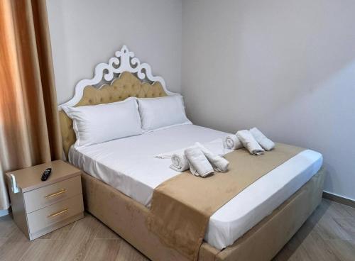 a bedroom with a bed with two pillows on it at Sweet Spot for Couples in Kamëz