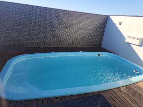 a blue bath tub sitting on a deck at Casa com Piscina in Londrina