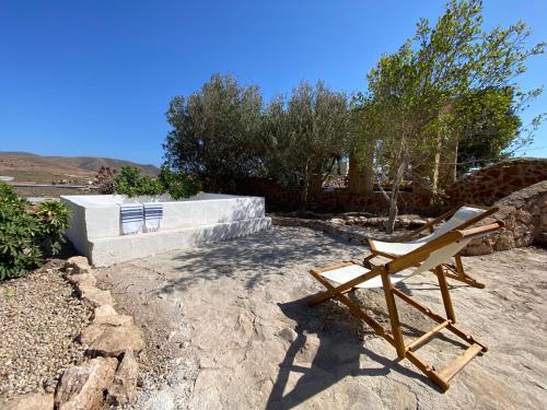 a chair sitting on the ground in a yard at Cortijo La Risca in Almería