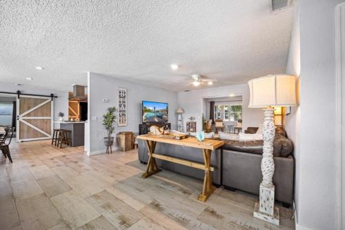 a living room with a couch and a table at Canal Front Beach Home, Private Pool in Flagler Beach