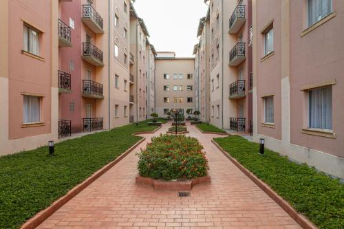 an alley between two buildings with flowers in the middle at Rio Quente Resorts - Hotel Giardino in Rio Quente