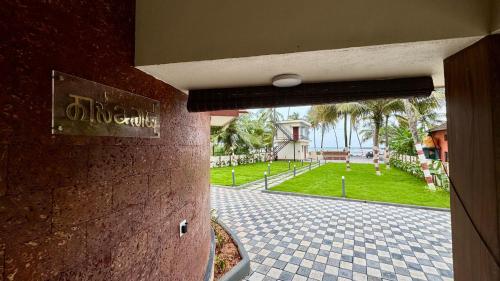 a door to a building with a view of a park at Casa Nada Beach Villa in Udupi