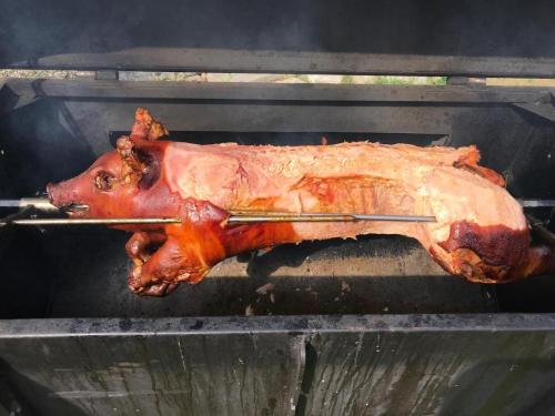a turkey is being cooked on a grill at Elitní wellness penzion U Dvou jedlí v srdci Českého ráje in Turnov