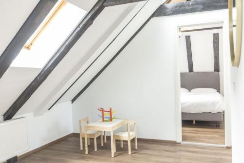 a bedroom with a bed and a table with a table at Hotel de France in La Chaux-de-Fonds