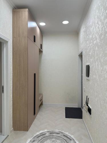 a room with a hallway with a door and a rug at Al-Beruni 4 in Dushanbe