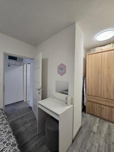 a small room with a desk and a bedroom at Tiny House Ciciban - self check in and check out in Otočac
