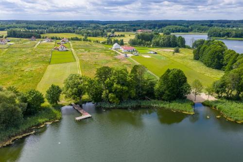 an aerial view of a river with trees and aestead at Osada Kalwa in Tylkowo