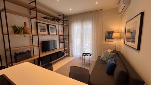 a living room with a couch and a television at Andreas and Nelly in Thessaloniki