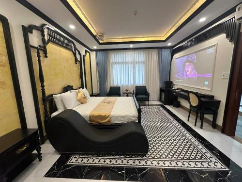 a bedroom with a large bed and a projection screen at Love Luxury Hotel Vườn Lài in Ho Chi Minh City