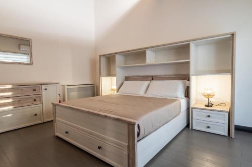 a large bedroom with a large bed and shelves at Alcantara Domus in Roccella Valdemone