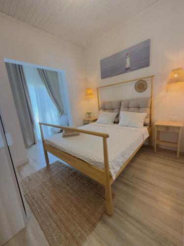 a bedroom with a bed in a room with a window at Villa Agora Nea Kalikratia in Nea Kalikratia
