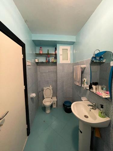 a bathroom with a toilet and a sink at appartement al hoceima à louer in Al Hoceïma