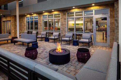 a fire pit in the middle of a patio at Home2 Suites By Hilton Clearwater St. Petersburg Ulmerton Rd in Clearwater