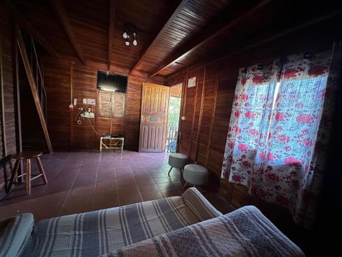 a bedroom with a bed and a tv in a room at Chalé em camping in Itu