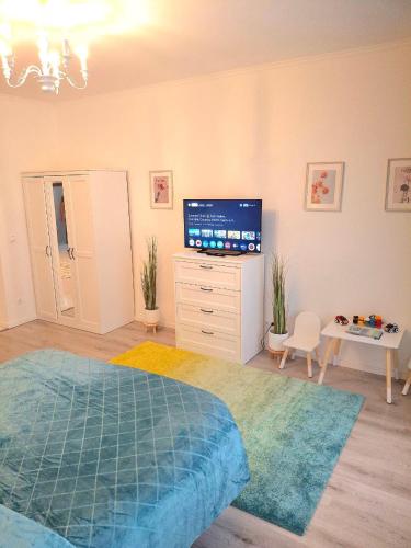 a bedroom with a bed and a flat screen tv at Family Design Apartments 2 rooms Neunkirchen 3 in Neunkirchen