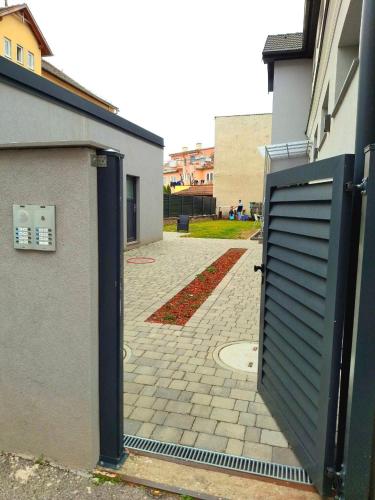 an open door to a building with a brick courtyard at Family Design Apartments 2 rooms Neunkirchen 3 in Neunkirchen