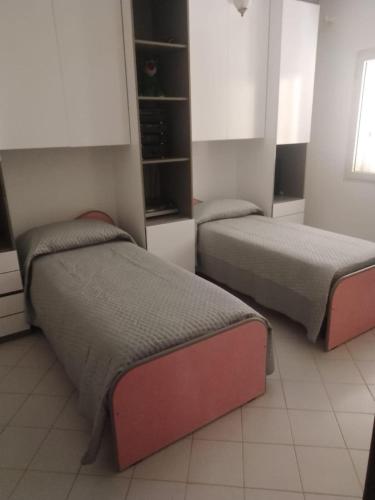 a room with two beds in a room at Casa di lella in Olbia