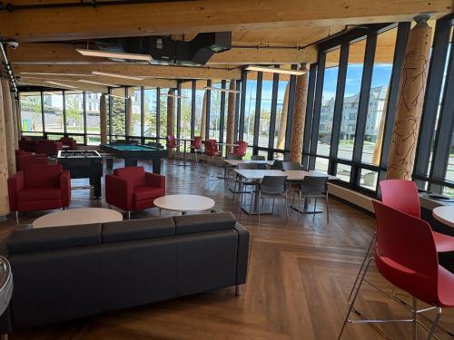 a lobby with a couch and chairs and tables at Residence & Conference Centre - Kelowna in Kelowna