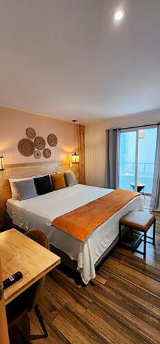a hotel room with a large bed and a window at La Martina Boutique Hotel in Medellín