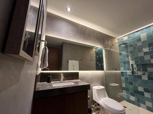 a bathroom with a toilet and a sink and a mirror at Brand New on 5th Av The vibrant hearth of the city in Cedro