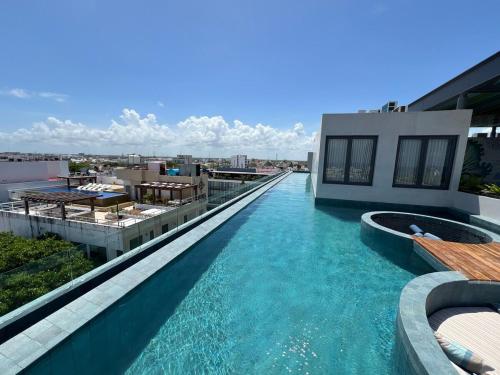 a swimming pool on the roof of a building at Brand New on 5th Av The vibrant hearth of the city in Cedro