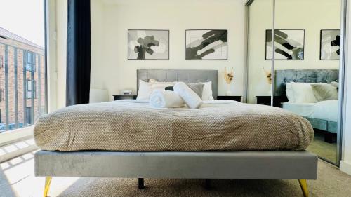 a bedroom with a large bed with pillows on it at Entire Luxury 2 Bedroom Apartment - Quiet & Central with Free Parking in Birmingham