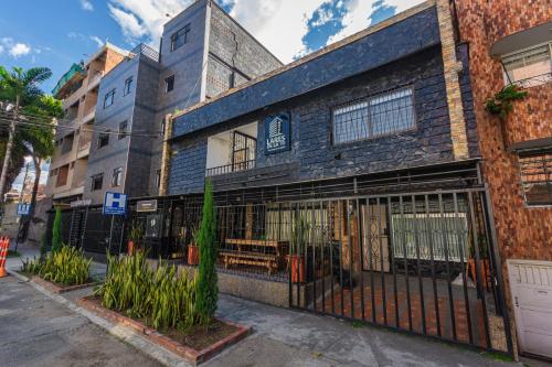 a building with a gate in front of it at Hotel Lares 70 Laureles in Medellín