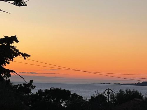 a view of the ocean at sunset at Studios Angeliki in Lassi