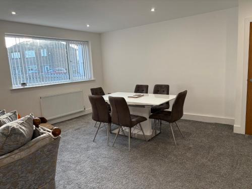 a meeting room with a white table and chairs at Thirlmere View Helmshore in Haslingden