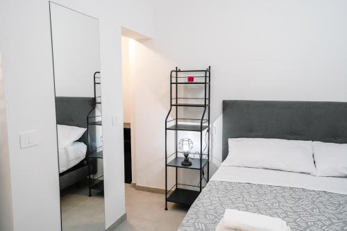 a bedroom with a bed with a black head board at Domus Picena - Suites & Relax in Grottammare