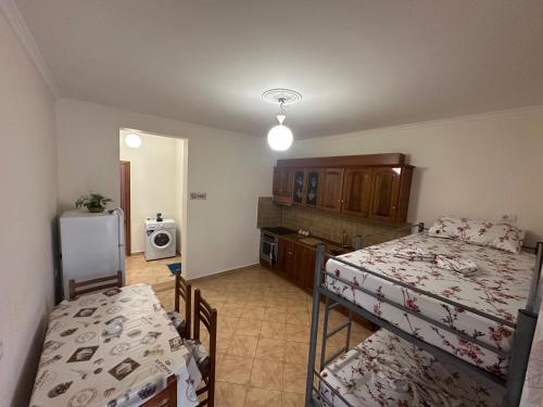 a small room with two beds and a kitchen at Dori 102 Apartment in Polisi i Vogël