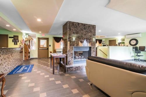 a living room with a fireplace and a couch at Rodeway Inn Towanda in Towanda