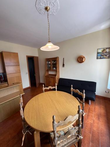 a dining room with a table and a couch at B&B Garzola in Ossuccio