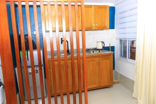 a kitchen with wooden cabinets and a counter top at 1 Bedroom Apartment in Douala
