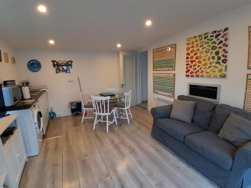 a living room with a couch and a table at Butterfly Cottage Retreat - Private Studio Getaway in Delvin