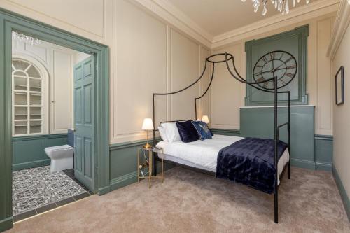 a bedroom with a canopy bed and a bathroom at The Hutton Suite in Marske