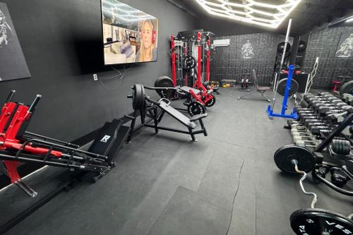 a fitness room with a gym with several machines at Healing Adventures in Claxton