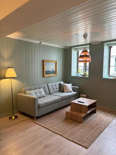 a living room with a couch and a coffee table at Apartment in old Stavanger in Stavanger