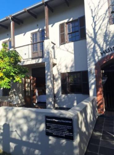 a building with a sign in front of it at Apartment in central Stellenbosch in Stellenbosch