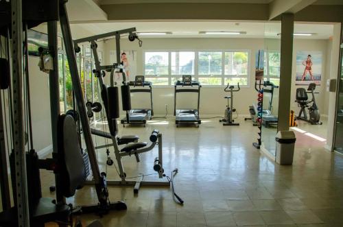 a gym with several treadmills and exercise bikes at Hotel City Hall in São José dos Campos