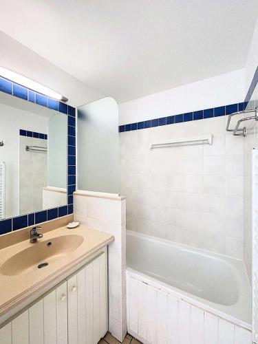 une salle de bain avec un lavabo, une baignoire et un miroir dans l'établissement Résidence Bleu Marine - Appartement vue mer 4 personnes, résidence avec piscine, Lacanau Océan MAE-0461, à Lacanau